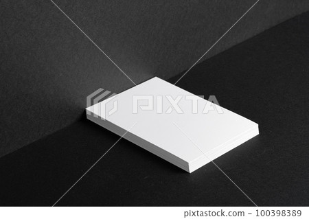 Stacked white businesscards for branding identity on black background Stacked white businesscards for branding identity on black background 100398389