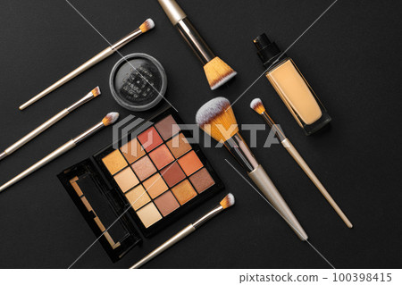 Professional makeup brushes and tools, make-up products set on dark table Professional makeup brushes and tools, make-up products set on dark table 100398415