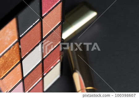 various makeup products on black texture background. various makeup products on black texture background. 100398607