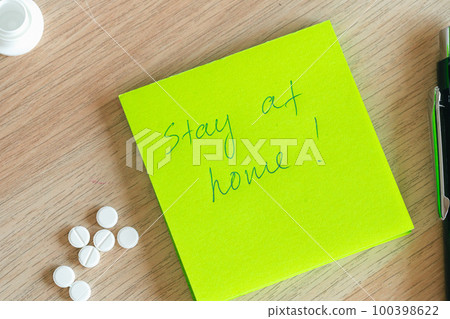 Stay at home written on an adhesive note. Coronavirus quarantine concept 100398622