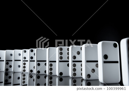 White dominoes in the dark close up 100399961