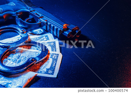Gun and judge's gavel on the table. Crime, robbery, attack concept 100400574