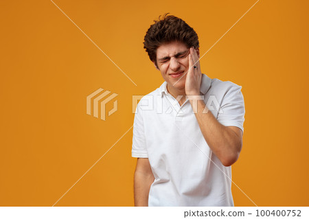 Young handsome man over yellow background touching mouth with hand Young handsome man over yellow background touching mouth with hand 100400752