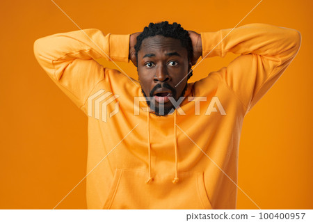 Young african anxious man worried nervous fail problem over yellow background 100400957