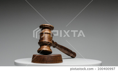 Brown wooden judge gavel on gray background 100400997
