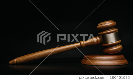 Wooden court gavel on black background close up 100401023