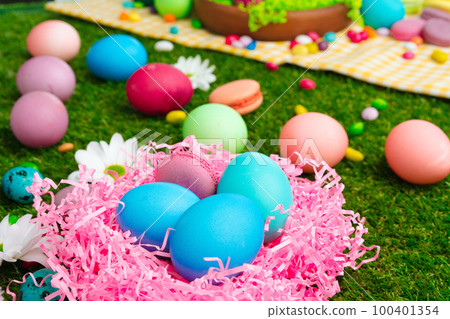 Colored eggs and vibrant candies on grass. Easter composition Colored eggs and vibrant candies on grass. Easter composition 100401354