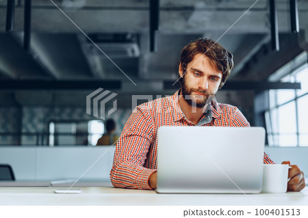 Puzzled thoughtful businessman sitting at his working table in an office Puzzled thoughtful businessman sitting at his working table in an office 100401513