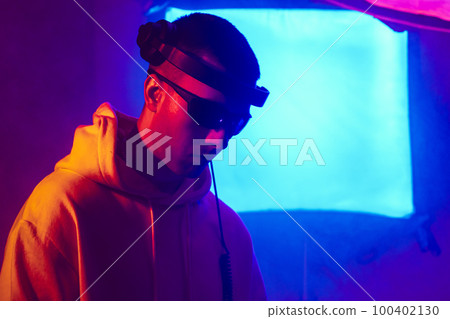 Male DJ playing music in the night club Male DJ playing music in the night club 100402130