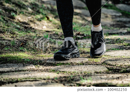 Athlete running feet 100402250