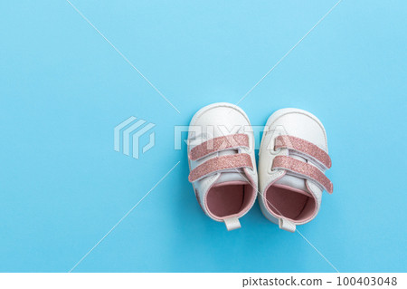 Baby shoes on paper background with copy space. Baby clothes concept. Top view, flat lay 100403048