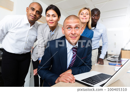 Closeup of surprised faces of businesspeople looking at camera in office 100405310
