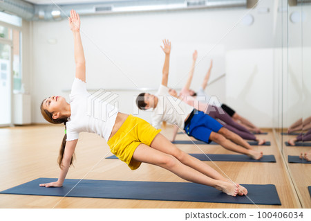 Girl practicing yoga at studio with family Girl practicing yoga at studio with family 100406034
