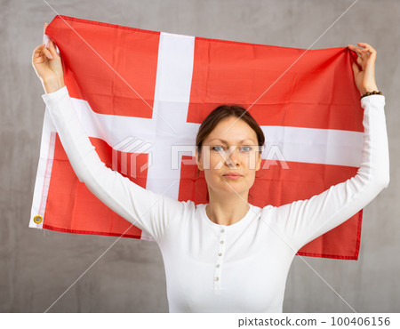 Young cheerful woman holding Denmark flag Young cheerful woman holding Denmark flag 100406156