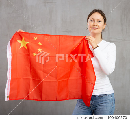 Happy smiling woman proudly displaying chinese flag Happy smiling woman proudly displaying chinese flag 100406270