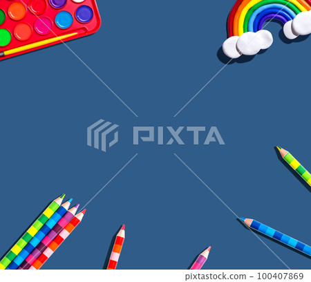 Art supplies with a rainbow - flat lay 100407869