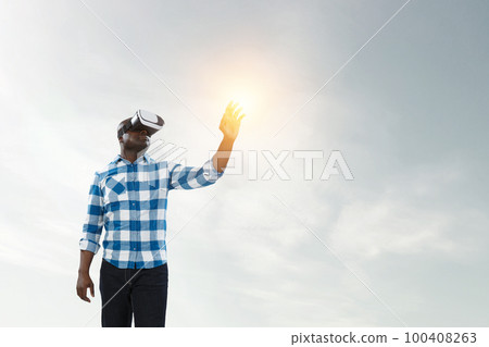 Man wearing virtual reality goggles Man wearing virtual reality goggles 100408263