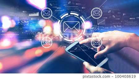 Email concept with person using a smartphone at night 100408619