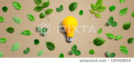Yellow light bulb with green leaves 100408650