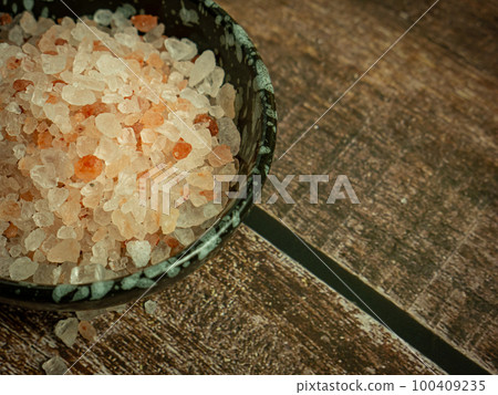 The pink salt or himalaya salt in small bowl on wood table for food or health concept The pink salt or himalaya salt in small bowl on wood table for food or health concept 100409235