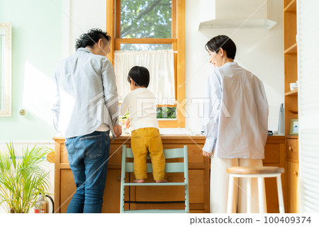 3 year old boy helping with cooking 100409374