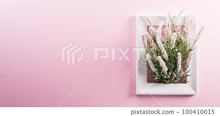 Happy Women's Day decoration concept made from flower and picture frame on pink pastel background. Happy Women's Day decoration concept made from flower and picture frame on pink pastel background. 100410015