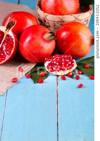Ripe pomegranate fruits on the wooden background 100411052