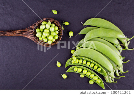 Sugar snap peas with mint on a rustic wood background 100411261
