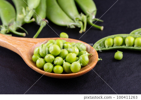 Sugar snap peas with mint on a rustic wood background 100411263