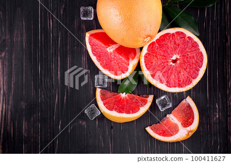 orange and grapefruit juice On a wooden black background 100411627