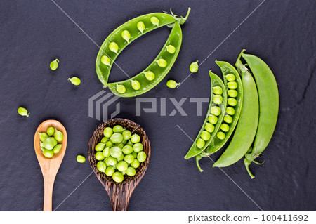 Sugar snap peas with mint on a rustic wood background 100411692