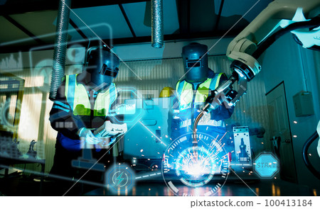Multiracial technicial engineer training with robot arm Multiracial technicial engineer training with robot arm 100413184
