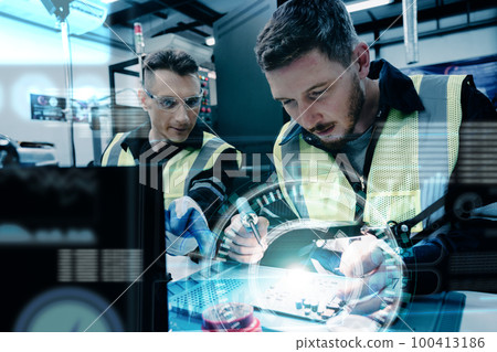 Multiracial technicial engineer training with robot arm Multiracial technicial engineer training with robot arm 100413186