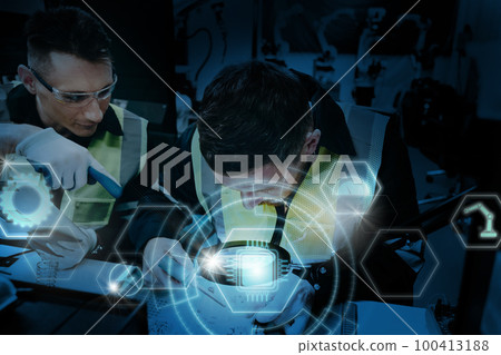 Multiracial technicial engineer training with robot arm Multiracial technicial engineer training with robot arm 100413188