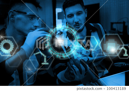 Multiracial technicial engineer training with robot arm Multiracial technicial engineer training with robot arm 100413189