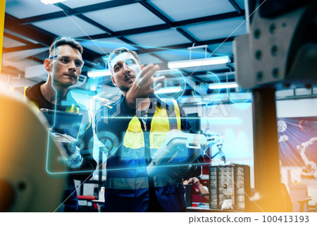 Multiracial technicial engineer training with robot arm Multiracial technicial engineer training with robot arm 100413193