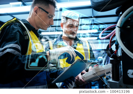 Multiracial technicial engineer training with robot arm 100413196