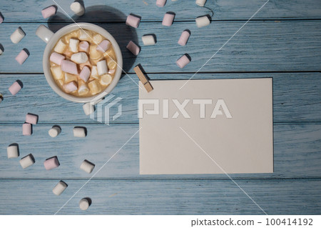 Empty greeting or invitation card mock up with white cup of coffee and marshmallows on wooden blue background. Blank paper copy space for your text. Valentines day, Happy fathers mothers day, Womens Empty greeting or invitation card mock up with white cup of coffee and marshmallows on wooden blue background. Blank paper copy space for your text. Valentines day, Happy fathers mothers day, Womens 100414192