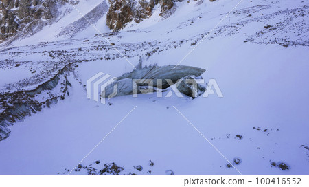 A huge ice wall from a glacier in the mountains. 100416552