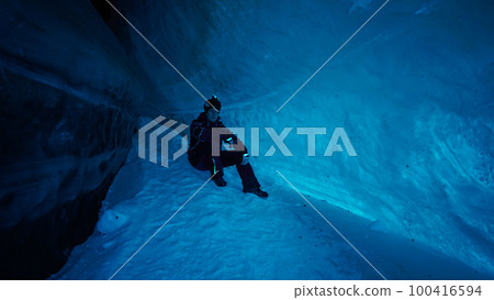 The climber made a halt inside an ice cave. The climber made a halt inside an ice cave. 100416594