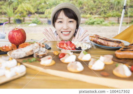 A young woman who is pleased with the completion of camping meals Camping outdoor image 100417302