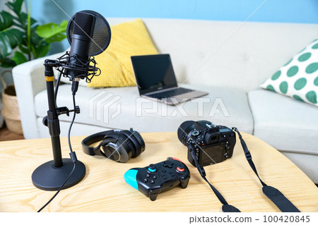 Arranging the equipment for game distribution Single-lens reflex camera, microphone and controller headphones YouTuber playing the game 100420845