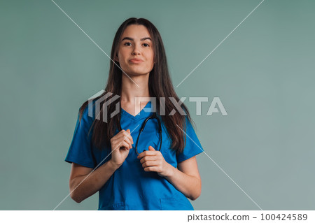 Portrait of young nurse with stethoscope, studio shoot. 100424589