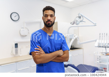 Portrait of young multiracial dentist at private dental clinic. 100424944