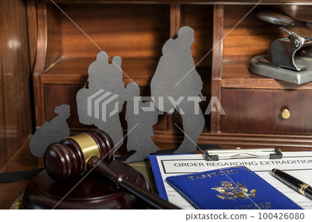 Immigration law concept. Gavel, passport and Silhouette of immigrants on wooden table. 100426080