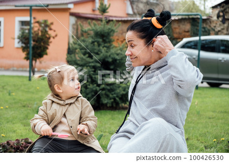 Grandparents in kids life and the unique benefits they can offer as caregivers and mentors. Senior woman grandmother and little toddler girl playing outdoor. playful activities with grandparents. Grandparents in kids life and the unique benefits they can offer as caregivers and mentors. Senior woman grandmother and little toddler girl playing outdoor. playful activities with grandparents. 100426530