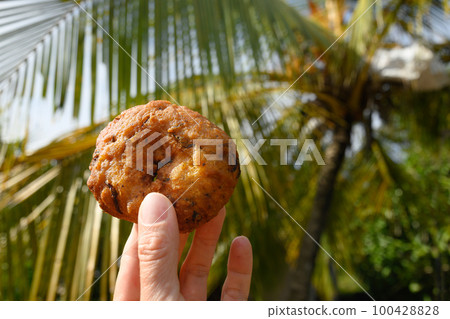 Ulundu Wade wonderful savoury dish in hand. Spicy lentil fritters. 100428828