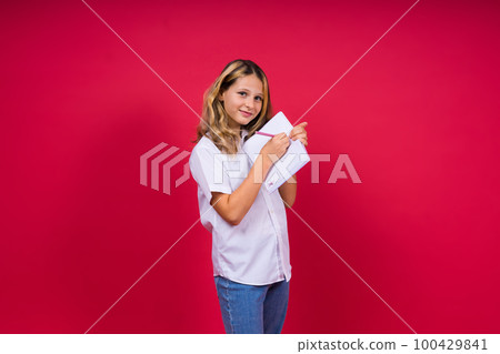 Child making notes. Kids dreams.Isolated on red background. Education, Kid back to school. 100429841