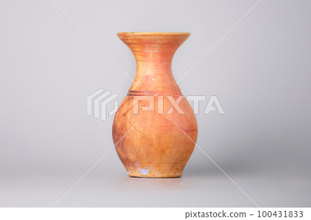 Used clay vase , pot on a gray background Used clay vase , pot on a gray background 100431833
