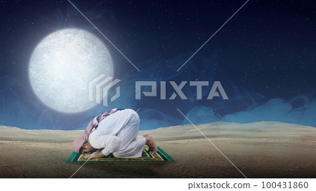 Muslim man with keffiyeh and agal in praying position (salat) on the prayer rug Muslim man with keffiyeh and agal in praying position (salat) on the prayer rug 100431860
